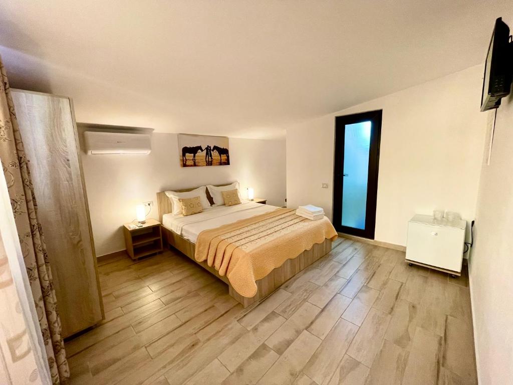 a bedroom with a bed and a large window at Vila Lorena in Mangalia