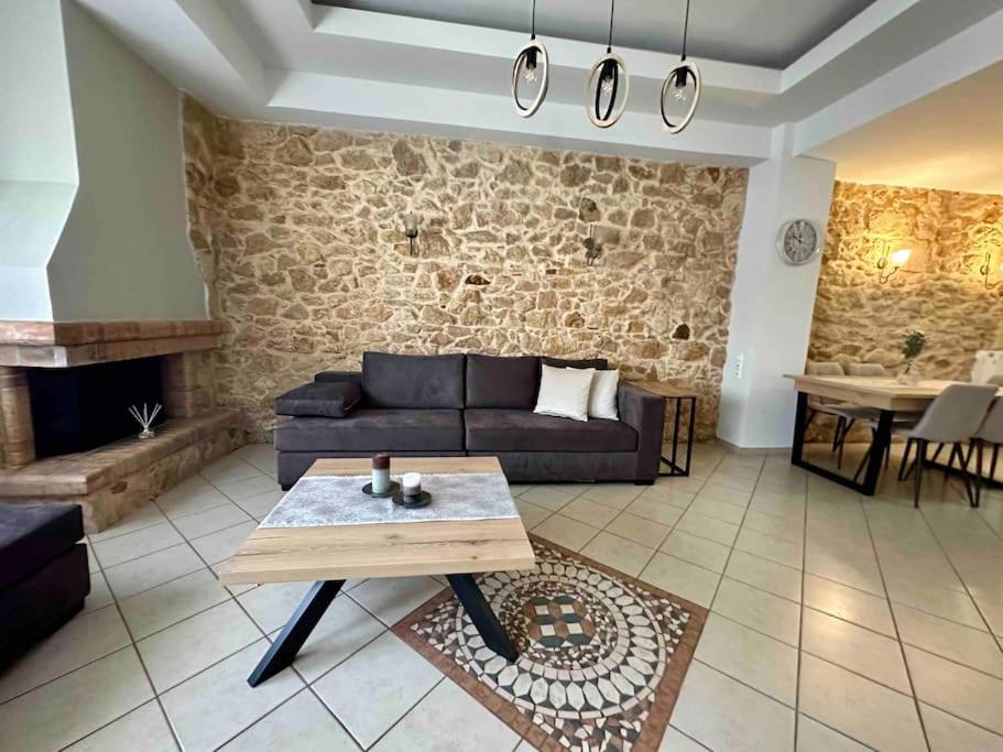 a living room with a couch and a table at SEAmpliCITY cozy apartment in Heraklio Town