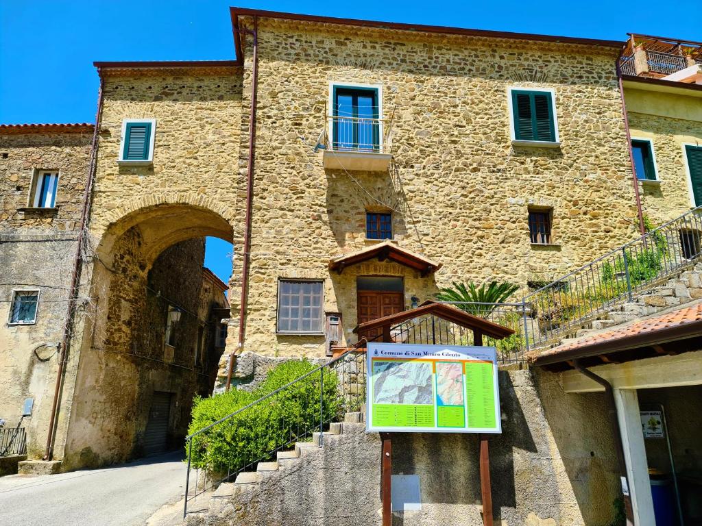 a building with a sign in front of it at Cilento Stone House in San Mauro Cilento