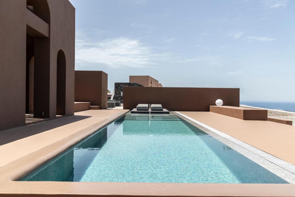 a swimming pool on the roof of a house at Serra Exclusive Suites in Akrotiri