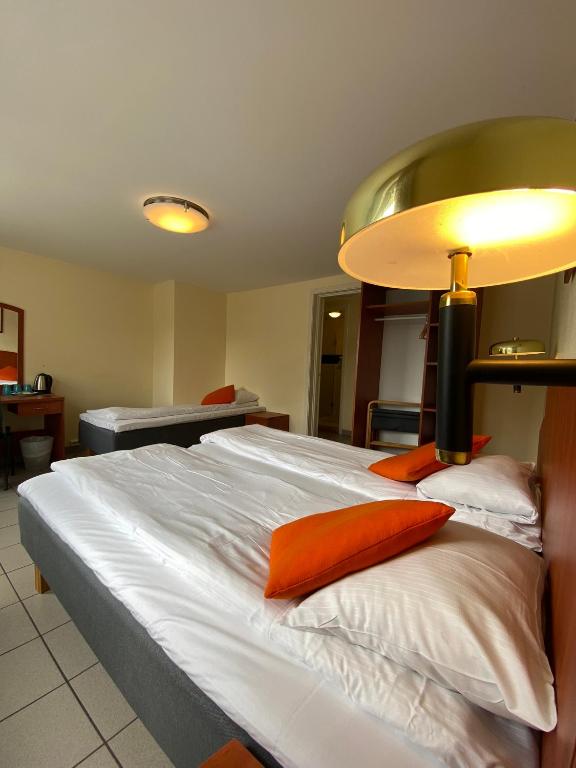 Postel nebo postele na pokoji v ubytování Lilland Brewery Hotel
