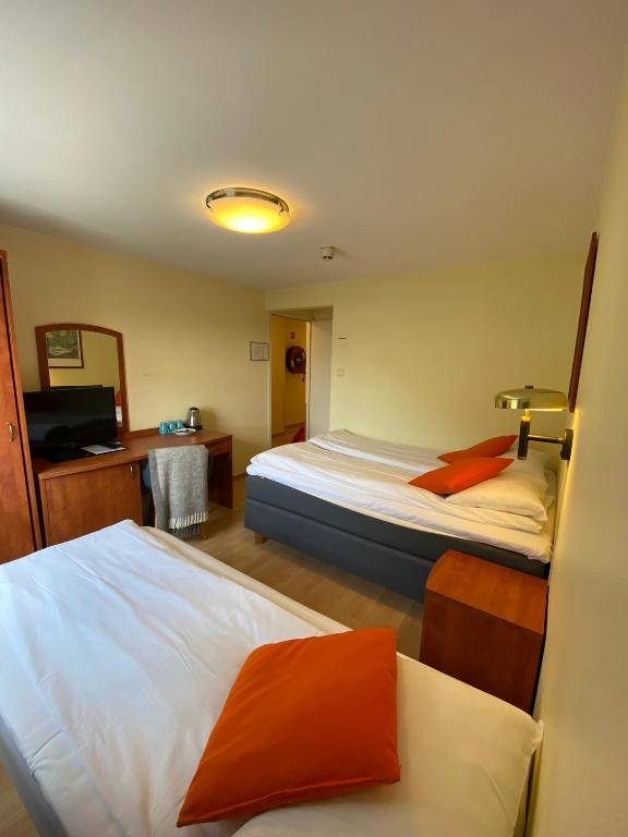 Postel nebo postele na pokoji v ubytování Lilland Brewery Hotel