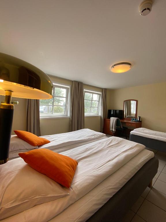 Postel nebo postele na pokoji v ubytování Lilland Brewery Hotel