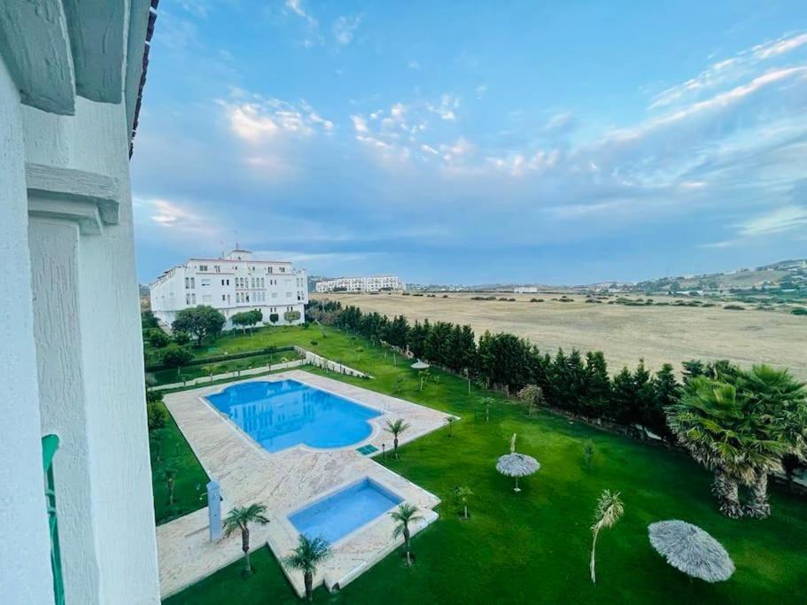 an aerial view of a building and a swimming pool at Apartamento vacacional achakar playa&piscina! in Tangier