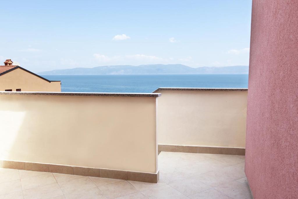 a balcony with a view of the ocean at Apartments Stanic in Ravni