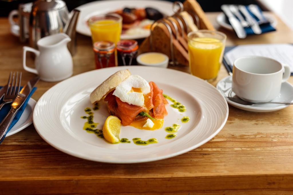a plate of food on a table with orange juice at The Randolph Hotel in Southwold