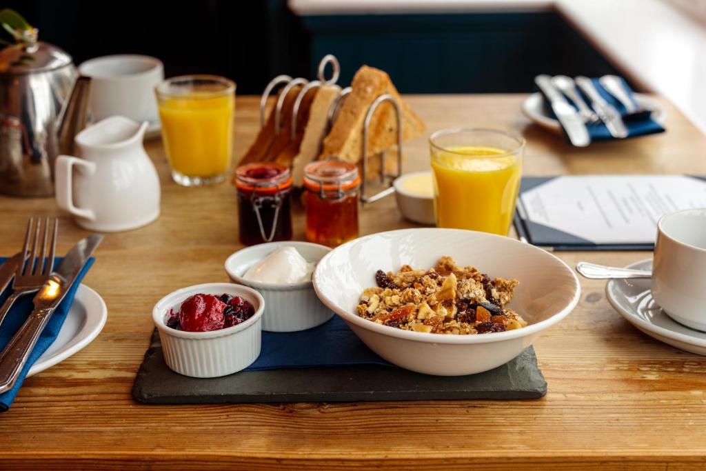 a table with a bowl of food and some drinks at The Randolph Hotel in Southwold