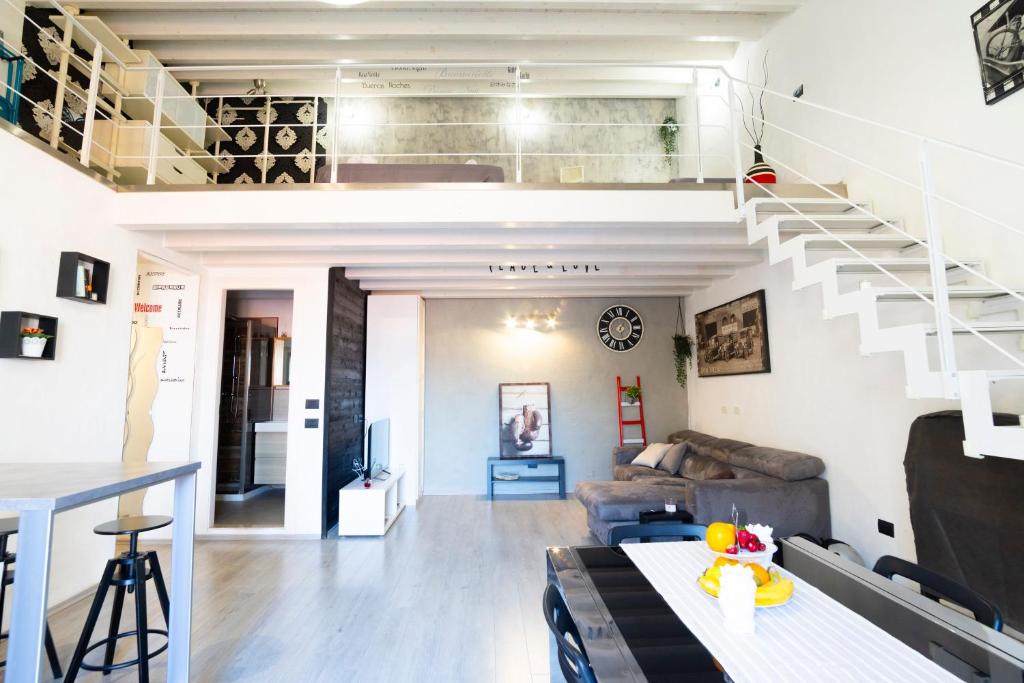 a living room with a loft with a staircase at Al Pozzillo casa vacanza SELF CHECK IN in Monreale