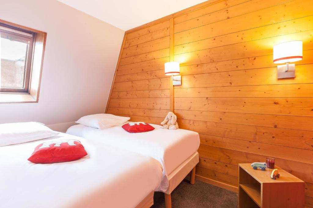 Кровать или кровати в номере Résidence Pierre & Vacances L'Ours Blanc