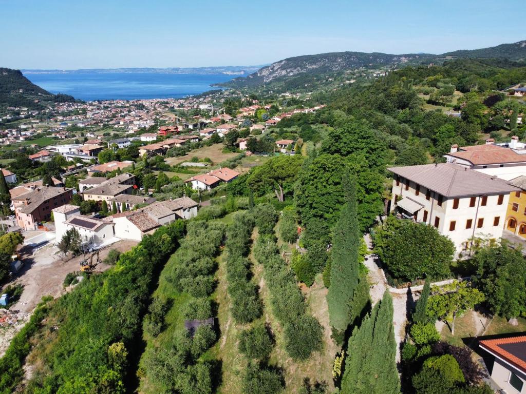 an aerial view of a small town with a house on a hill at Villa Montegolo in Costermano