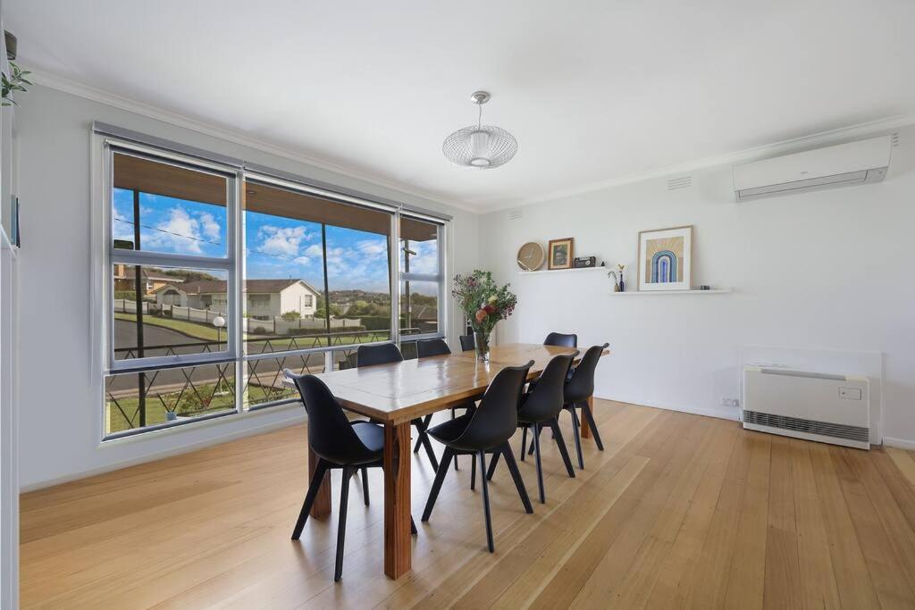 a dining room with a long table and chairs at Southern Ocean Retreat in Warrnambool