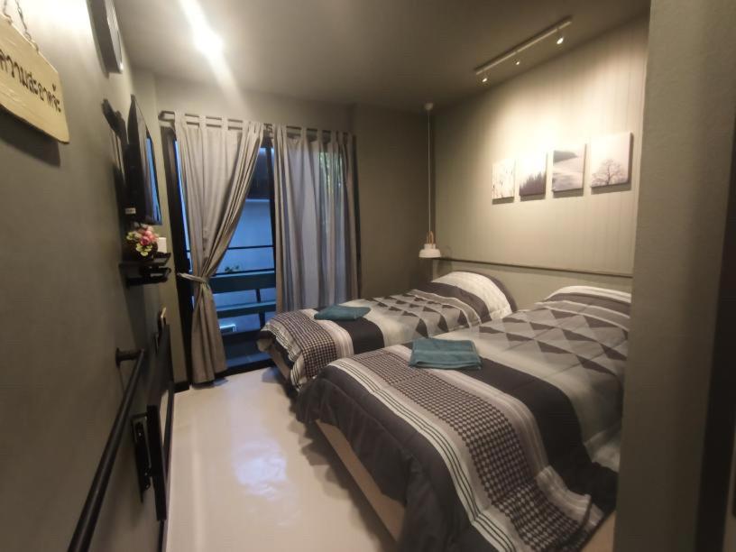 Postel nebo postele na pokoji v ubytování Rangyen Homestay Cha-Am รังเย็น