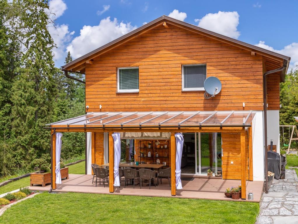 a house extension with a deck and a patio at Chalet Ester - Luxury Provençal House in Orava in Námestovo