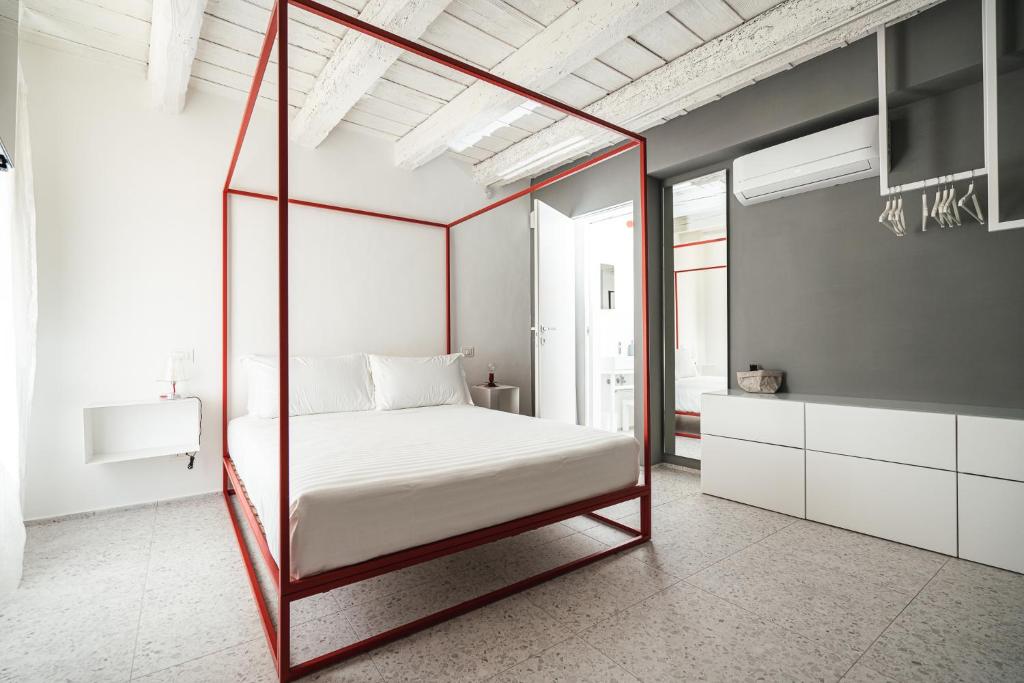 a bedroom with a canopy bed in a room at Casa Valentina in Senigallia