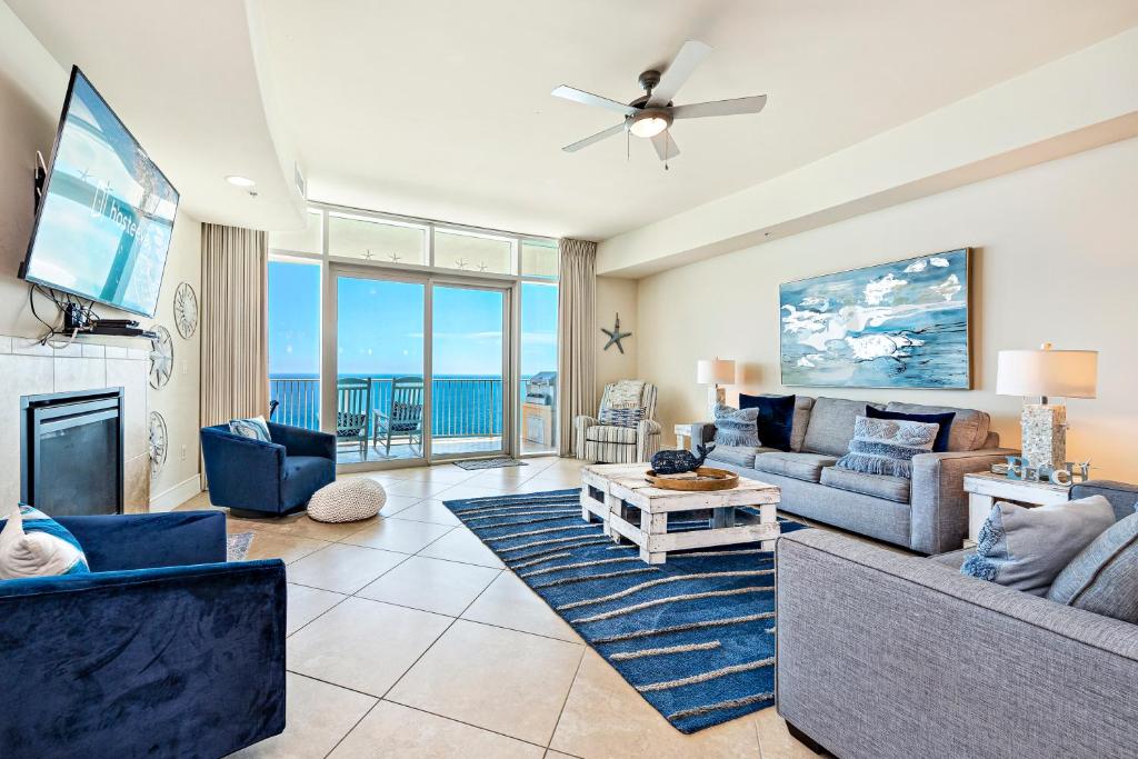 a living room with a couch and a tv at Turquoise 1908 C Turquoise Place in Orange Beach