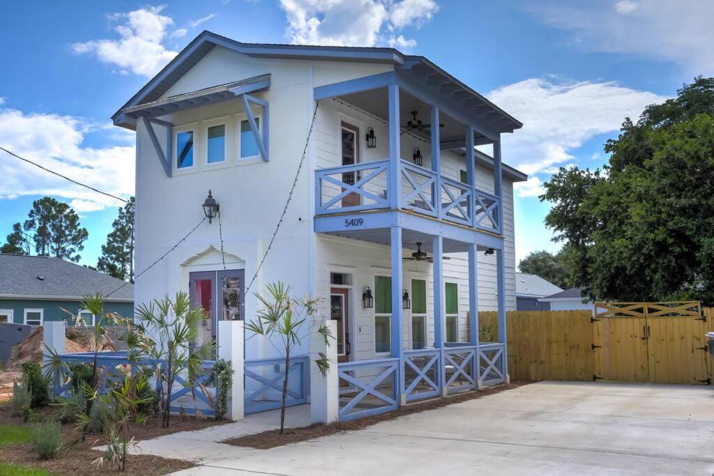a white house with a blue roof at La Casa Boheme in Pensacola