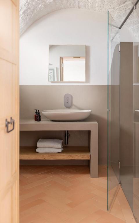 a bathroom with a sink and a mirror at Masseria Auraterrae in Polignano a Mare