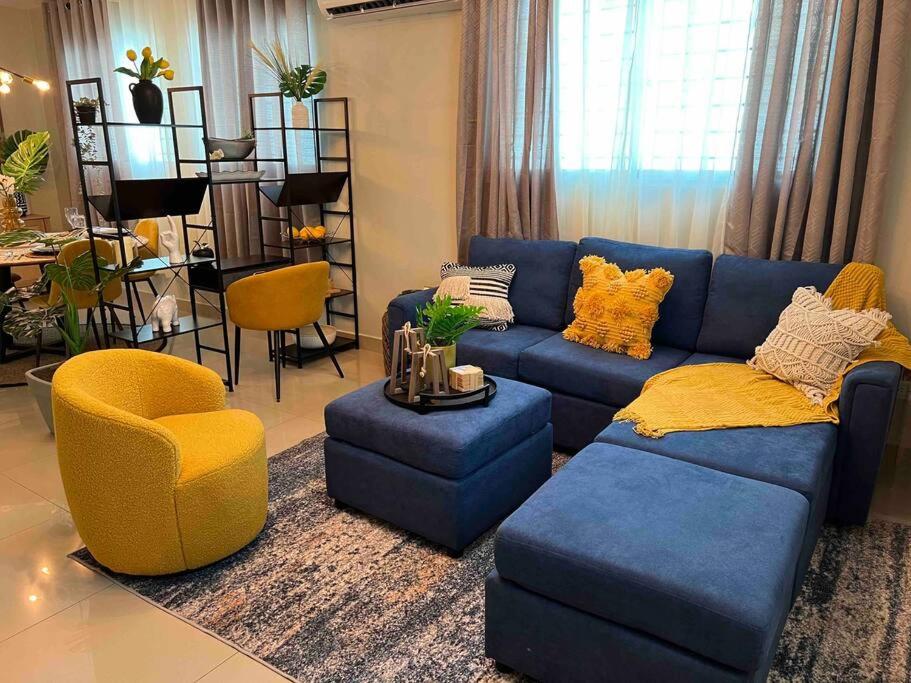 a living room with a blue couch and a yellow chair at Modern luxurious apartment in Santiago de los Caballeros