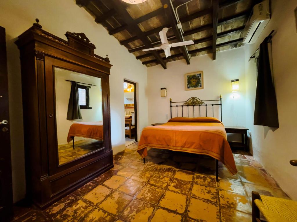 a bedroom with a bed and a mirror at La Casona de Moldes in Coronel Moldes