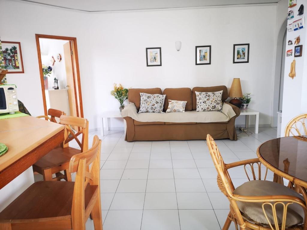 a living room with a couch and a table at Caparica Lounge & Terrace in Costa da Caparica