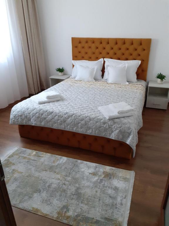 a bedroom with a large bed with two pillows at La SULINA in Sulina