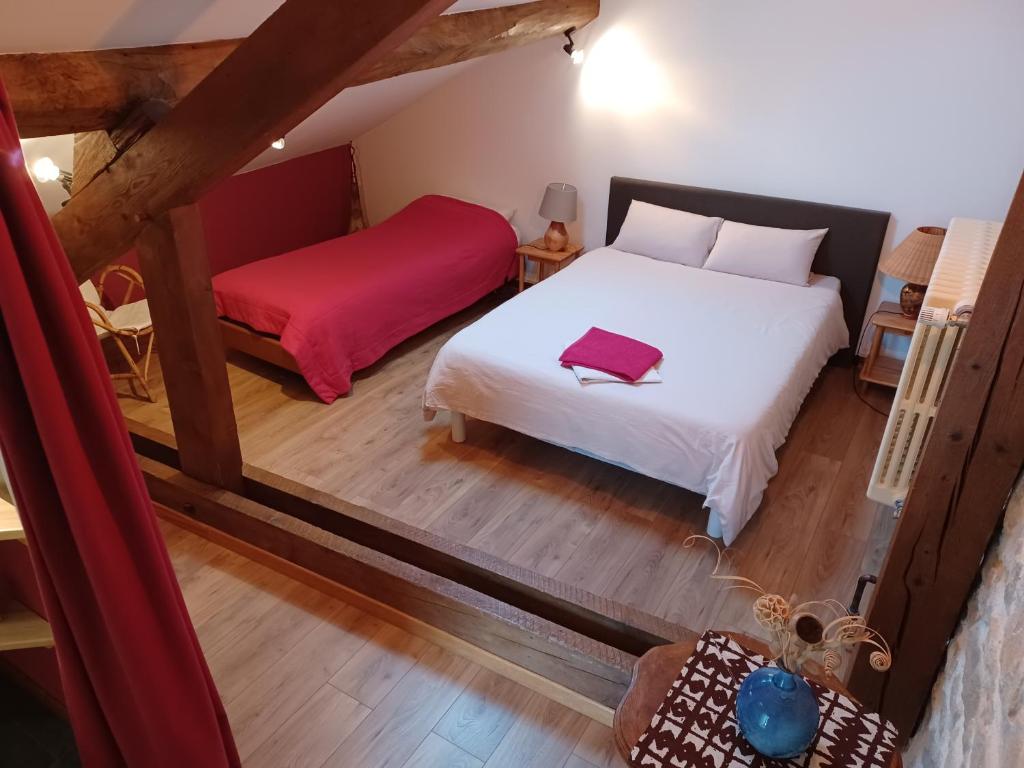 a bedroom with a white bed and a red blanket at 2 chambres privées au calme à la Maison des Bambous in Dijon
