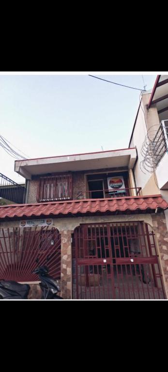 a building with a gate in front of it at Atardeceres in Puntarenas