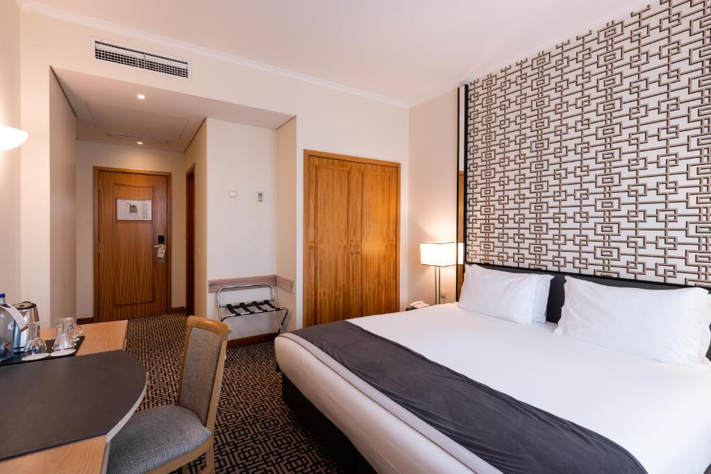Ein Bett oder Betten in einem Zimmer der Unterkunft Hotel Mundial