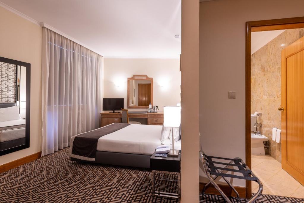 Ein Bett oder Betten in einem Zimmer der Unterkunft Hotel Mundial