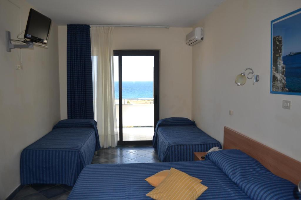 Postel nebo postele na pokoji v ubytování Hotel Jonic