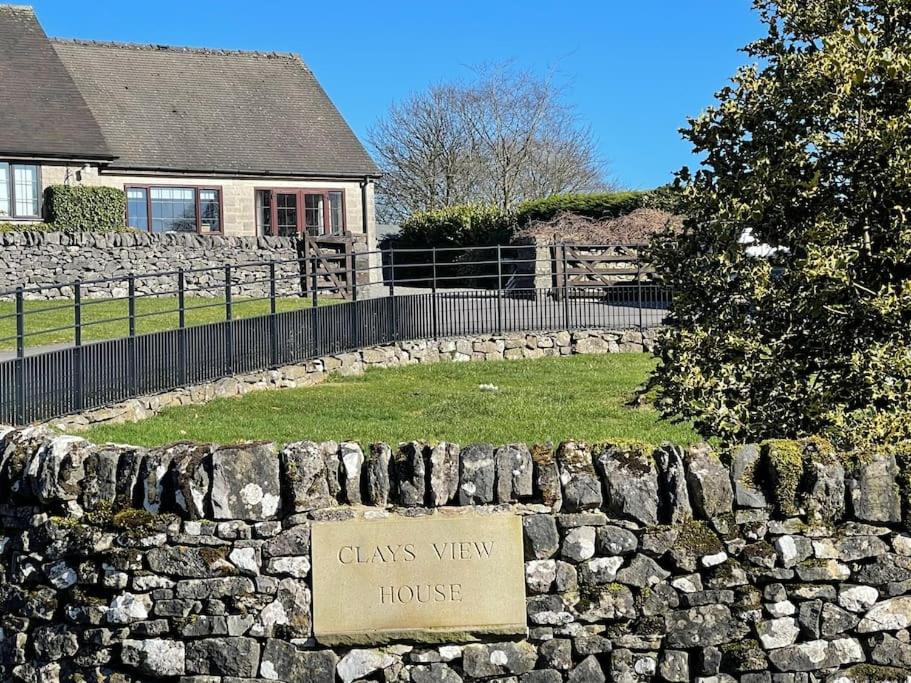 a stone wall with a sign that reads glass view house at Clays View Alstonefield in Alstonfield