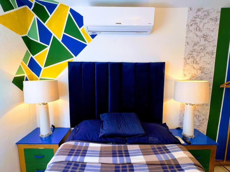 a bedroom with a bed with two lamps on it at CASA Privada Wifi CLIMAParking Netflix REFRI Micro in Monterrey