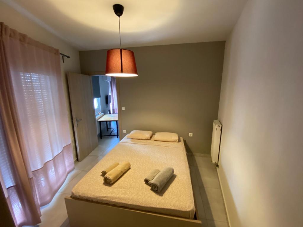 a bedroom with two beds with towels on it at Voulas suites in Eleftheroúpolis