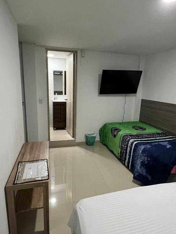 Postel nebo postele na pokoji v ubytování EDIFICIO Niza80 IBAGUE, ACCESO DIGITAL CERCA PARQUE DEPORTIVO