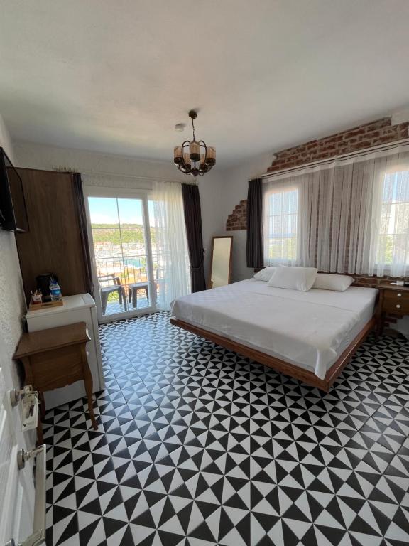 a bedroom with a bed and a black and white floor at Villa Veria in Çeşme