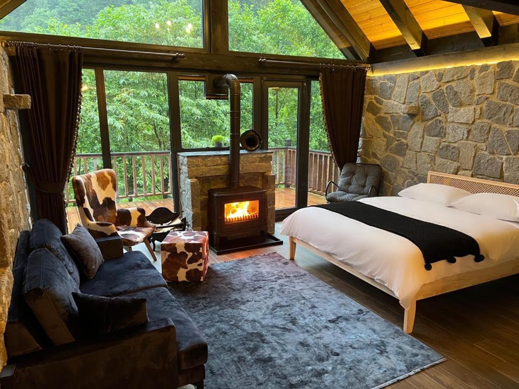 a bedroom with a large bed and a fireplace at AYDER VANAK STONE SUİTES in Ayder Yaylasi