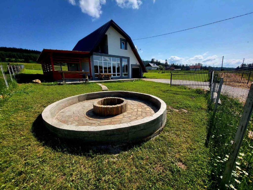 a fire pit in a yard in front of a house at Sarajevo NATURE Romanija in Sarajevo