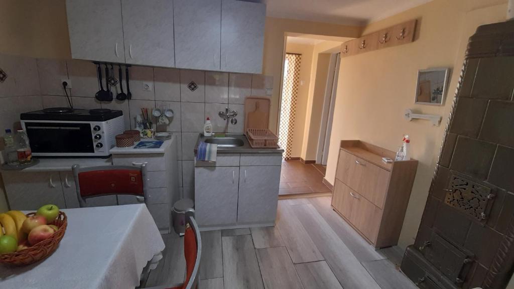 a kitchen with a bowl of fruit on a table at Centrala in Vrdnik