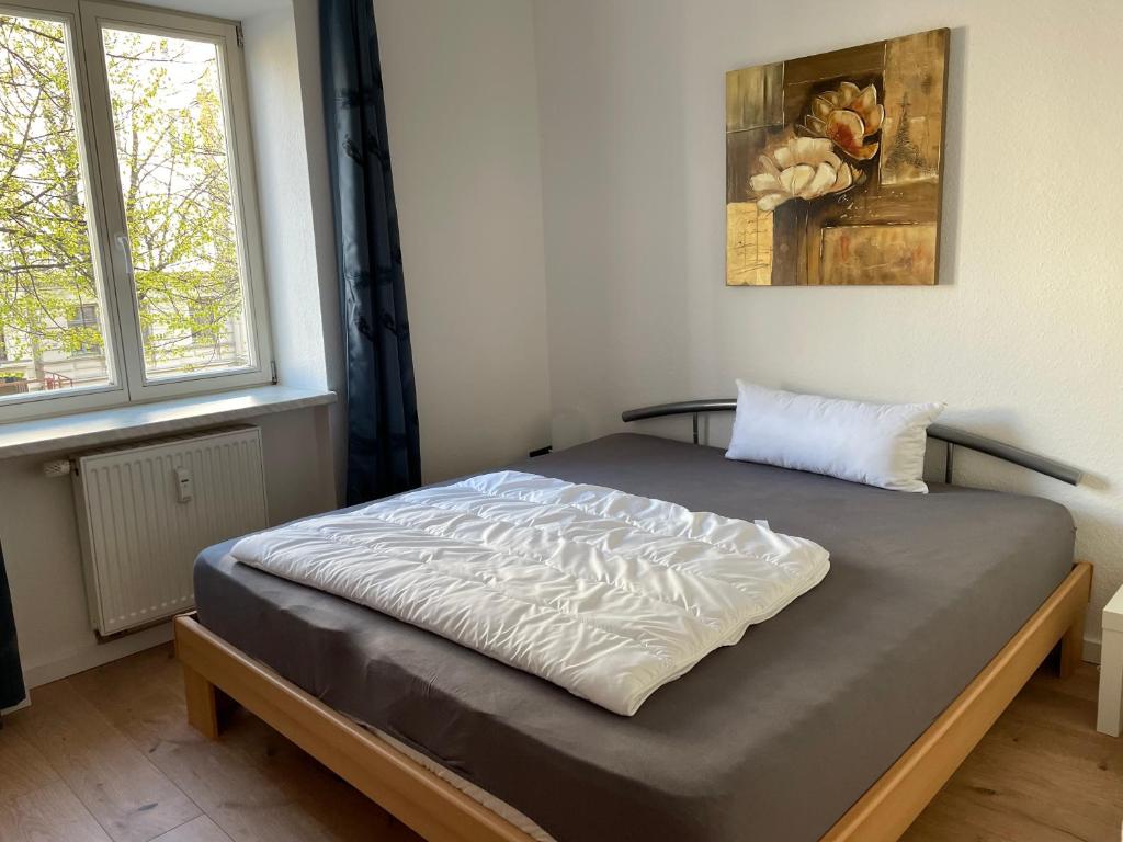 a bed sitting in a room with at Sueños Apartment in Magdeburg