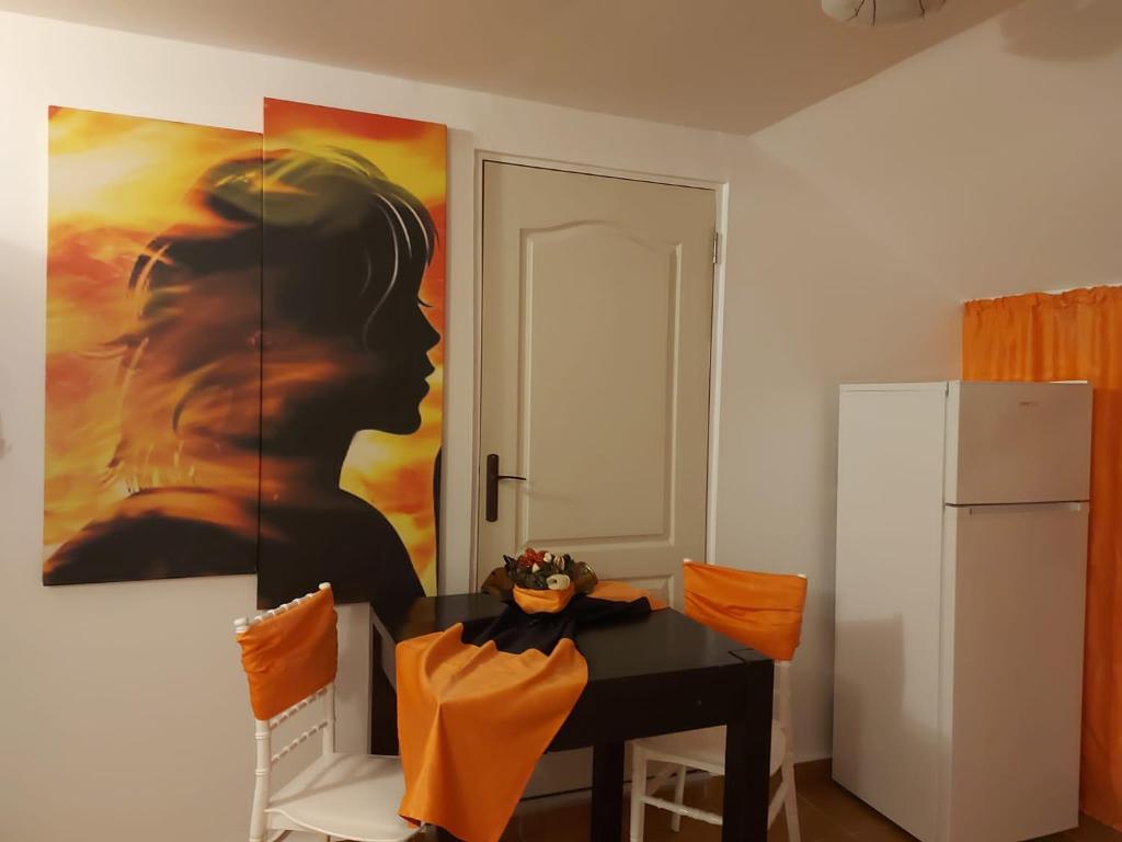 Legend Room في Pucioasa: غرفة طعام مع طاولة و لوحة على الحائط