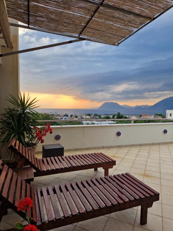 a balcony with a bench and a view of the city at V for the View in Patra