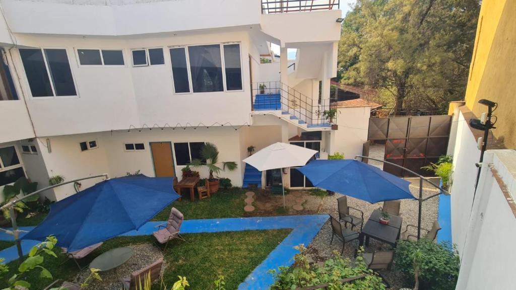 an aerial view of a house with blue umbrellas at HOSTAL DEL ELEFANTE in Tepoztlán