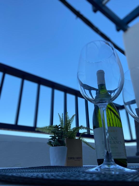 a bottle of wine sitting next to a wine glass at SHIOKAZE in San José