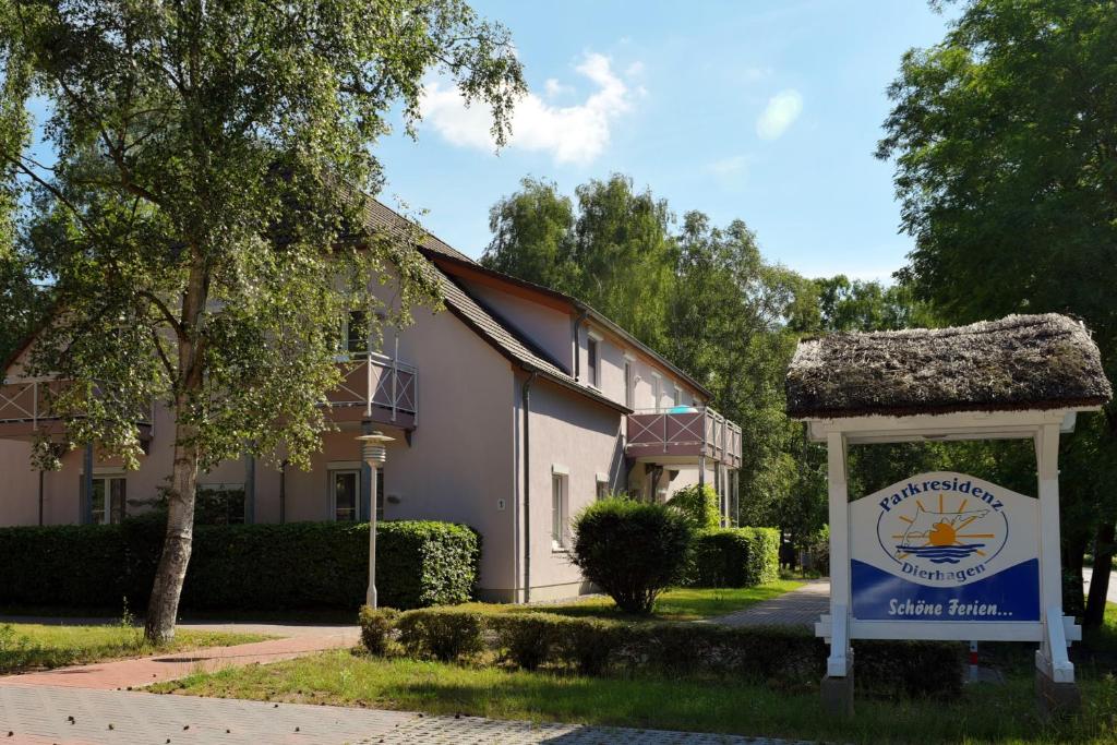 a building with a sign in front of it at Parkresidenz Dierhagen in Dierhagen