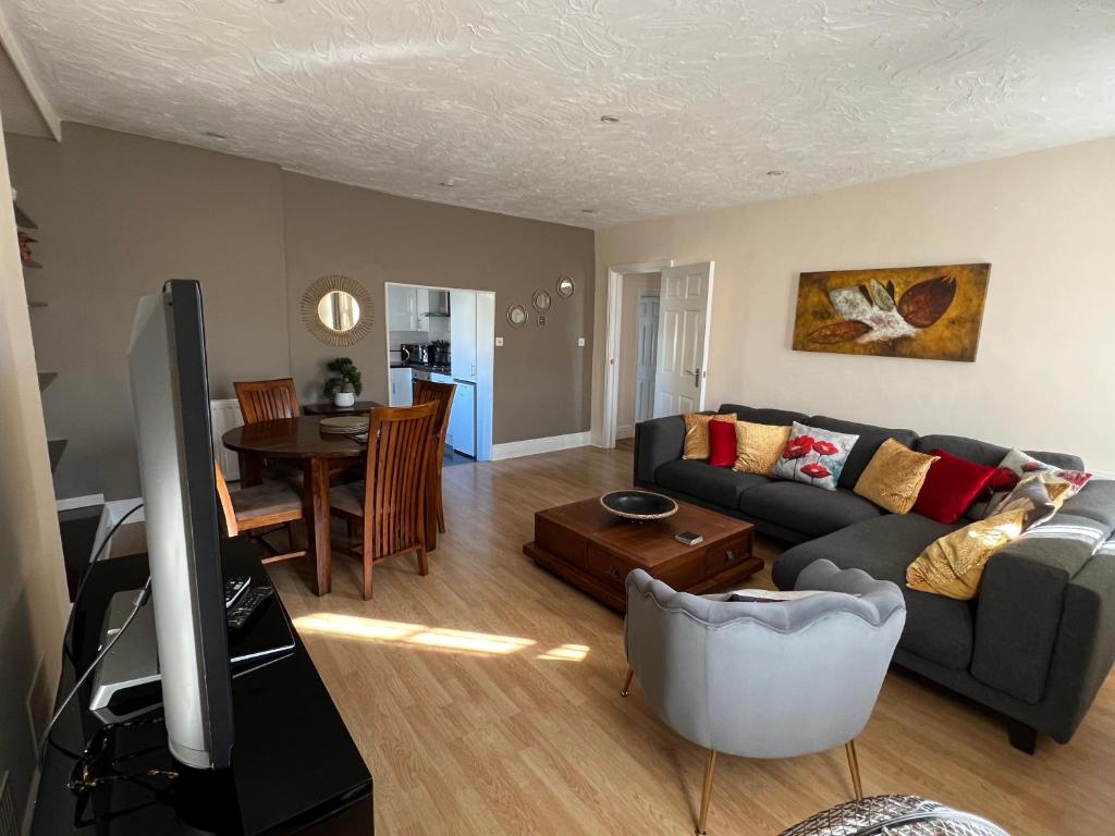 a living room with a couch and a table at Stay in Yeovil Town Centre, Large 2 BD Apt With Parking, Sleeps 4 in Yeovil