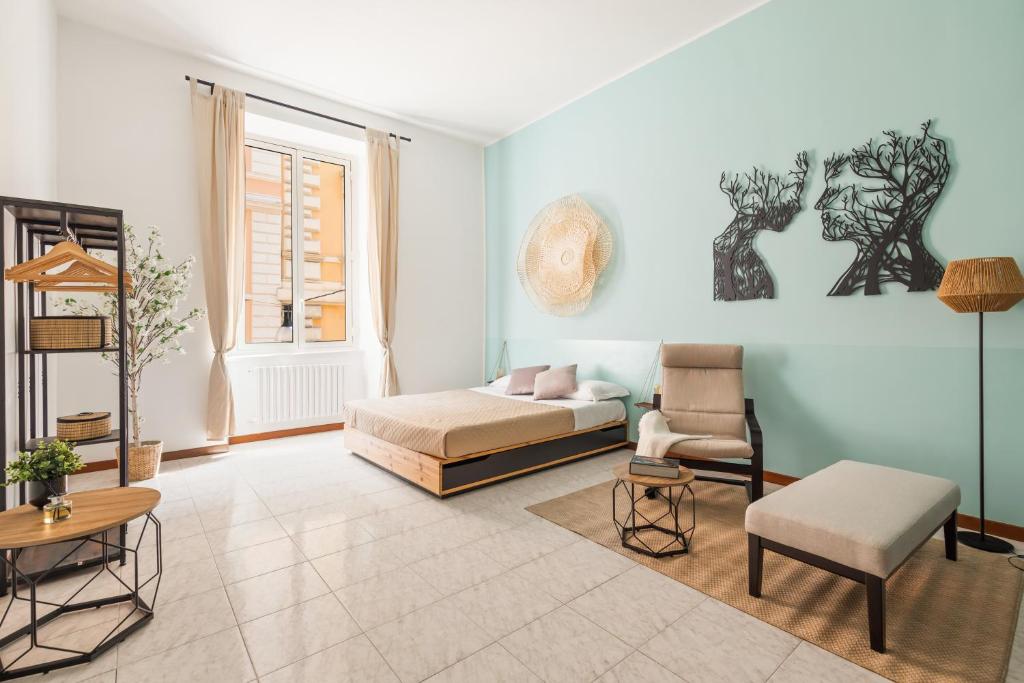 a living room with a bed and a chair at Imperial Nazionale in Rome