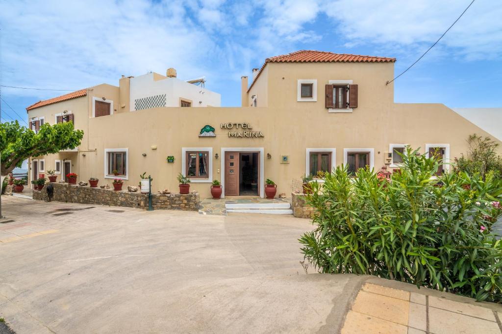 a large house with a driveway in front of it at Hotel Marina in Anogia