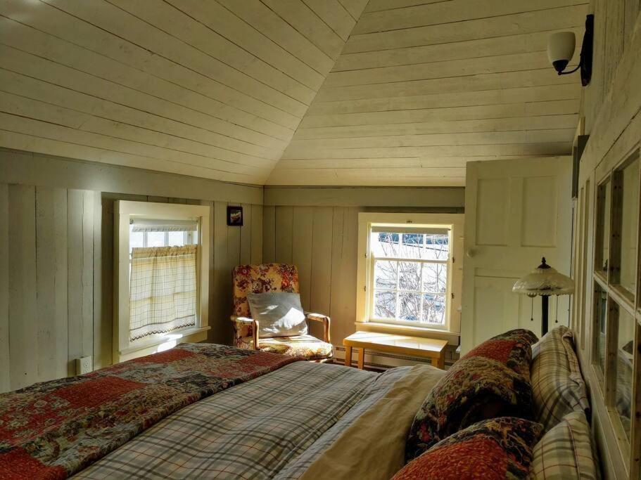 Dory Buff House في Princeton: غرفة نوم بسرير وكرسي في غرفة