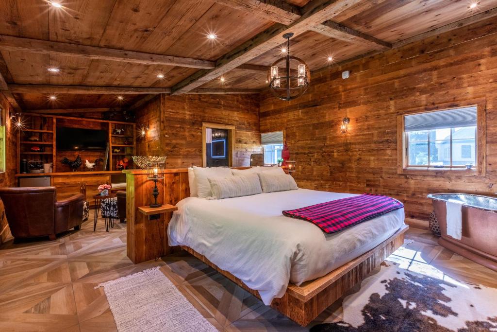 a bedroom with a bed and a wooden wall at The Barnstead Inn in Manchester Center
