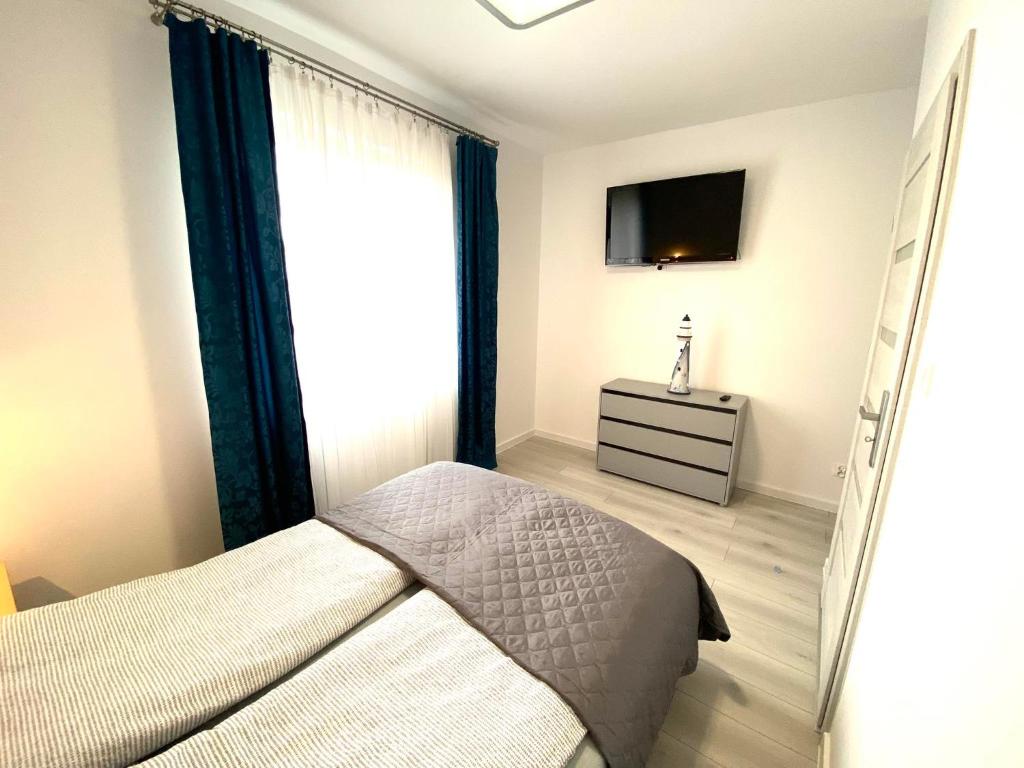 Posteľ alebo postele v izbe v ubytovaní apartament dla 4 osób blisko morza